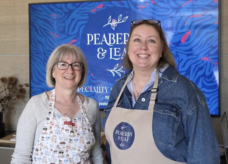 Cara smiling in her Peaberry and Leaf apron